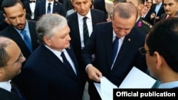 Turkey - Armenian Foreign Minister Edward Nalbandian gives Turkish President Recep Tayyip Erdogan a letter from his Armenian counterpart Serzh Sarkisian during his inauguration in Ankara, 28Aug2014.
