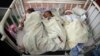 AFGHANISTAN -- Newborn babies lie in their beds at the Ataturk Children's Hospital a day after they were rescued following a deadly attack on another maternity hospital, in Kabul, Afghanistan, Wednesday, May 13, 2020. 