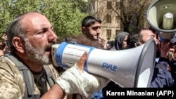 ARMENIA -- Opposition leader Nikol Pashinian (R) speaks in a megaphone as he takes part in an opposition rally in central Yerevan, April 17, 2018