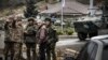 NAGORNO-KARABAKH -- Russian peacekeepers (R and 3rdR) stop a car at their checkpoint outside the city of Stepanakert, November 13, 2020