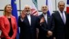Austria -- Iranian Foreign Minister Mohammad Javad Zarif (2nd L) gestures next to EU foreign policy chief Federica Mogherini (L), Iranian ambassador to IAEA Ali Akbar Salehi (2nd R) and Russian Foreign Minister Sergei Lavrov (R) as they pose for a photo in Vienna, 14Jul2015.