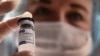 RUSSIA -- A medical worker holds a vial with Russia's Sputnik V vaccine against the coronavirus at a vaccination point at the GUM department store in Moscow, January 18, 2021.