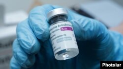 Armenia - A medical worker holds a vial of the Oxford/AstraZeneca coronavirus vaccine at a policlinic in Yerevan, April 28, 2021.