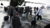 Russia -- Russian citizens, who were evacuated from Libya, leave a plane owned by the Emergency Situations Ministry as they walk along a landing runway at Domodedovo airport outside Moscow, 23feb2011