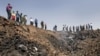 Iran -- Iranians gather the edge of a crater at the crash site of the Caspian Airlines plane, 15Jul2009