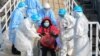 CHINA -- Medical staff transfer patients to the newly completed Huoshenshan temporary field Hospital in Wuhan, Hubei Province, February 4, 2020