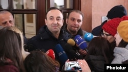 Armenia -- Constitutional Court Chairman Hrayr Tovmasian talks to reporters outside his home searched by law-enforcement officers, Yerevan, January 24, 2020.